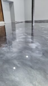 Metallic epoxy garage floor with marble-style finish and high-gloss surface
