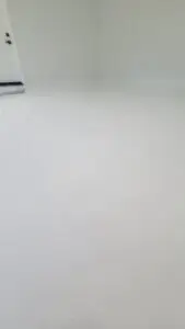 Matte white epoxy garage floor with clean modern finish