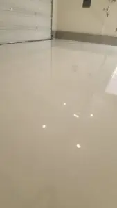 High-gloss white epoxy garage floor with reflective finish