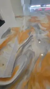 Custom metallic epoxy floor installation for residential garage with modern design